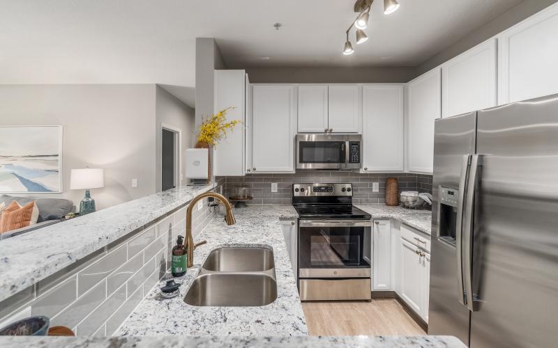 a kitchen with white cabinets