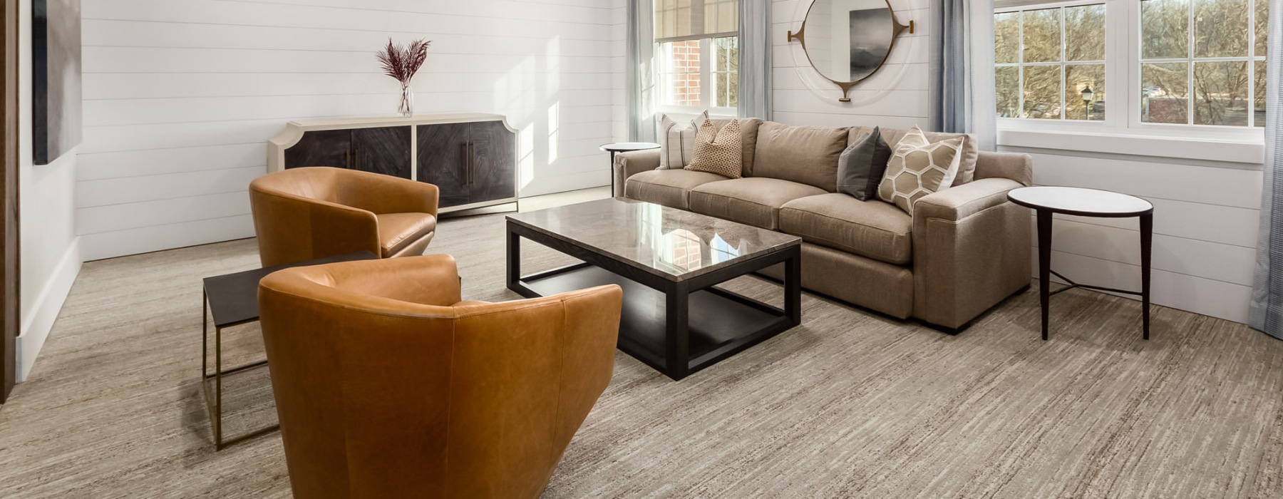 sun filled room with couch and chairs