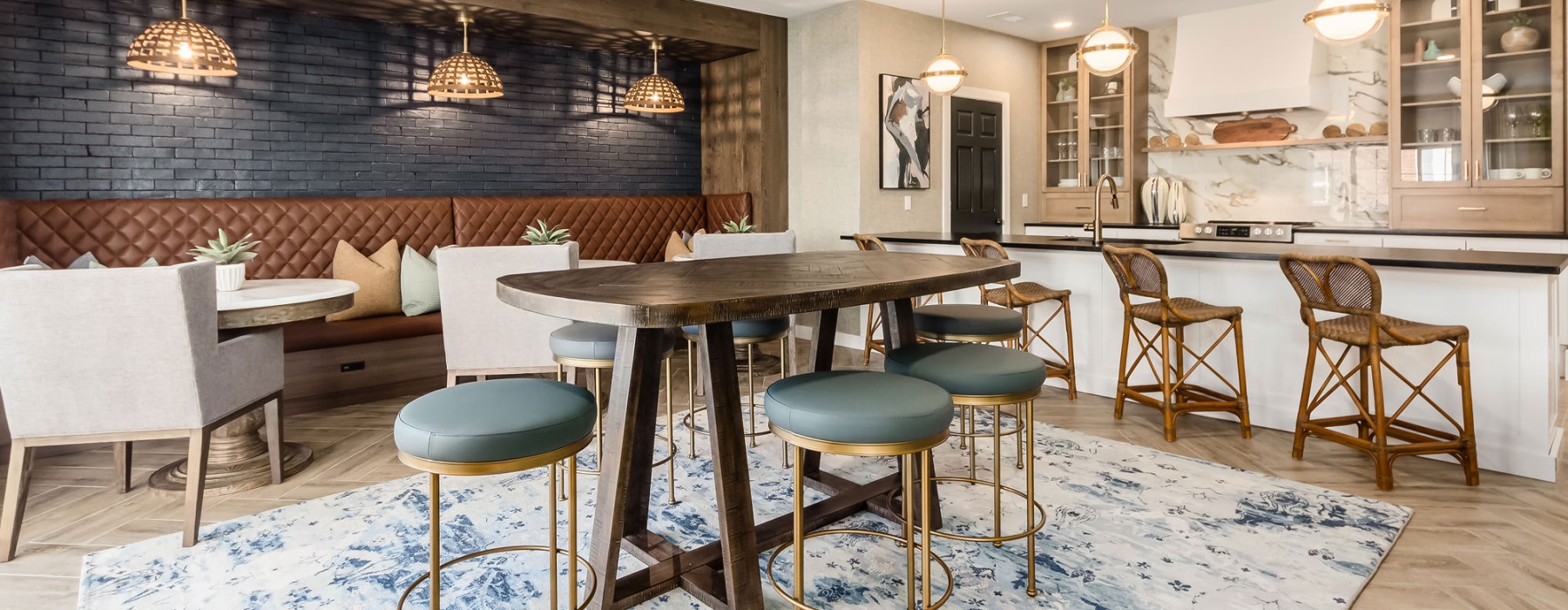 a large kitchen with a bar and chairs