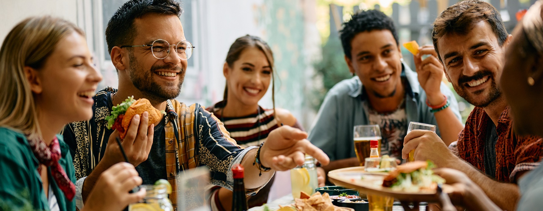 people at a table eating and laughing