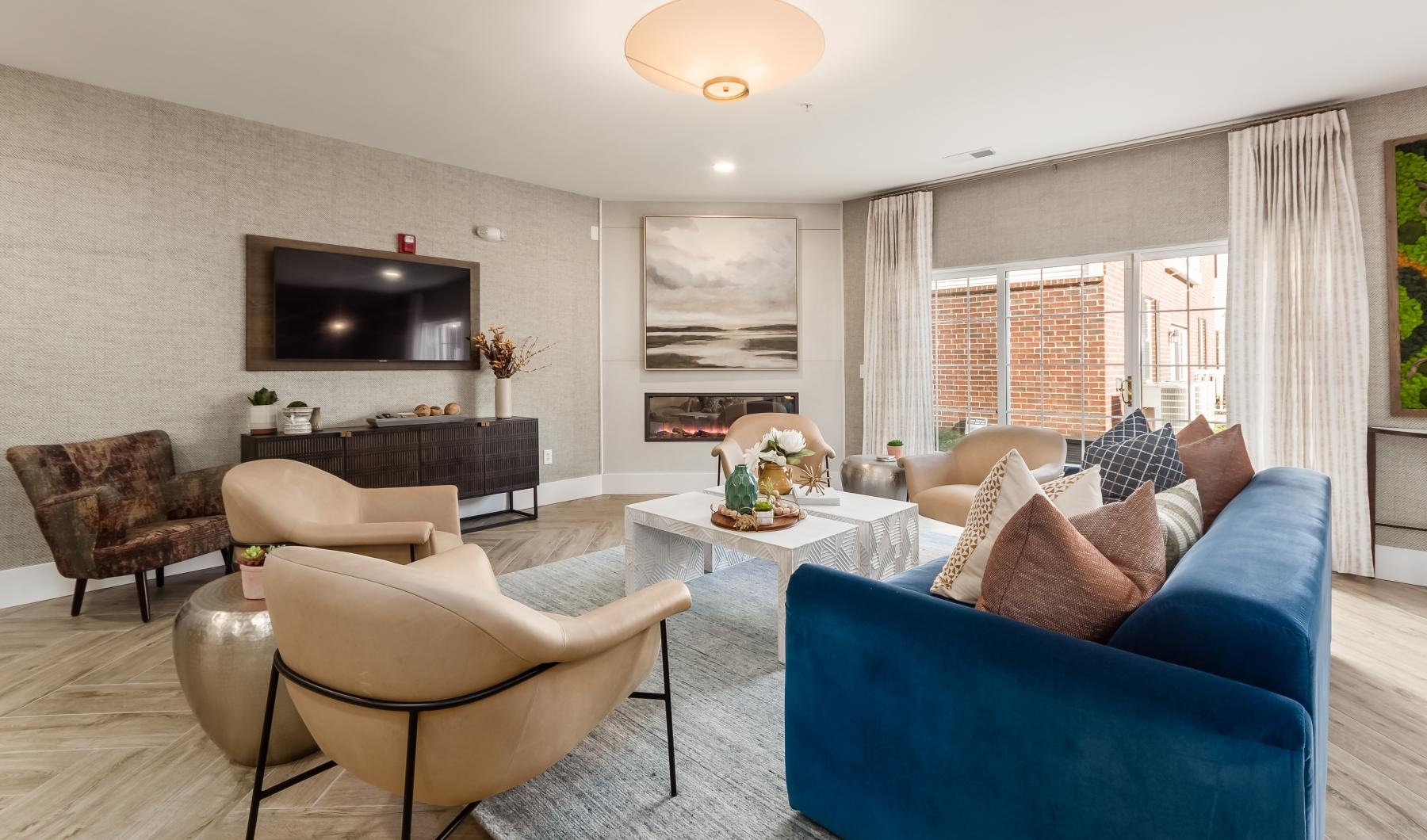 a living room with a blue couch and a tv